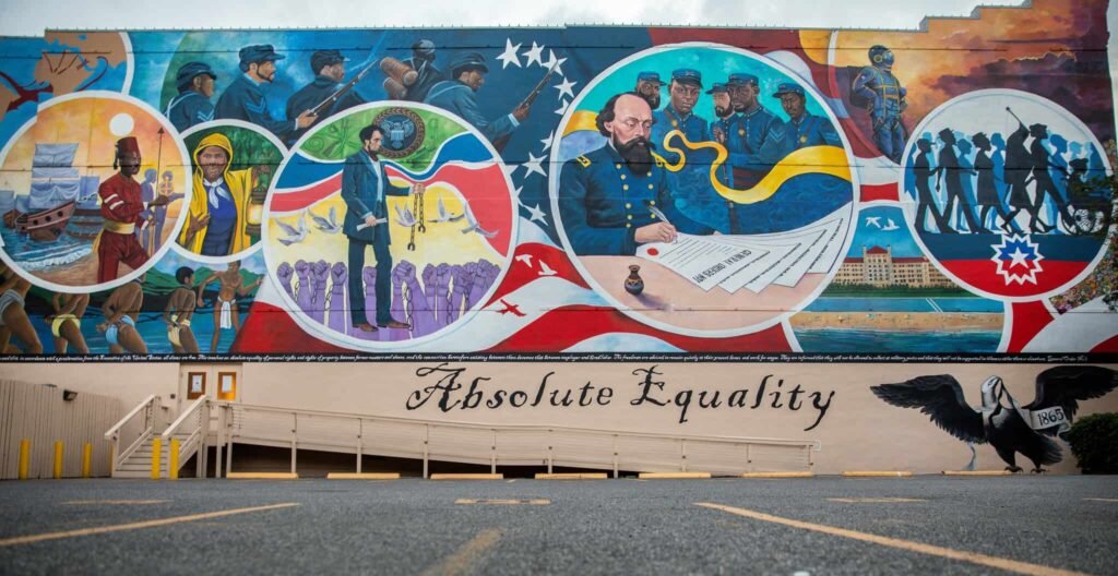 Closed in observance of Juneteenth. 1 A large mural illustrating the history of Juneteenth with the words Absolute Equality painted underneath