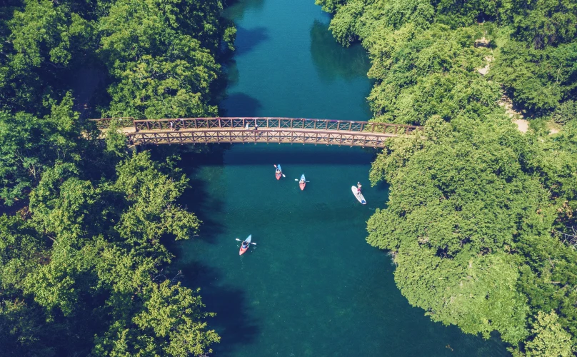 Drone shot of a bridge crossing over Barton Springs in Austin, Texas.
