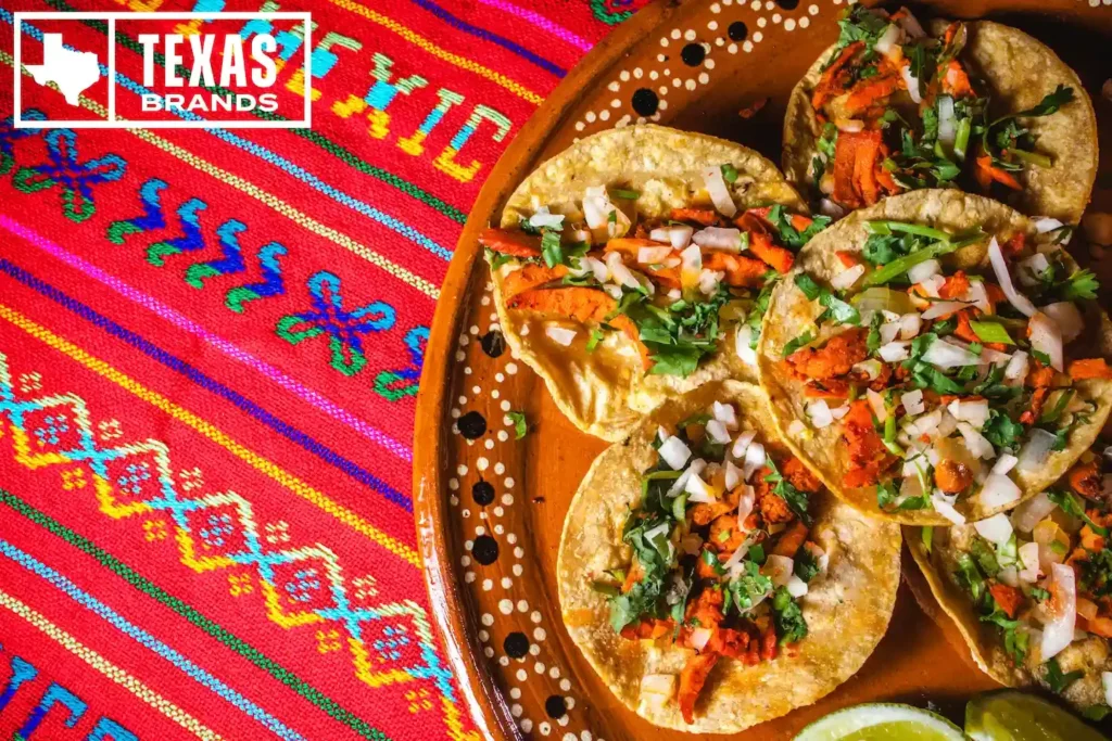 Plate of al pastor tacos on corn tortillas on a serving platter.